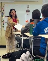 Litzy Ramos hanging papers to her students