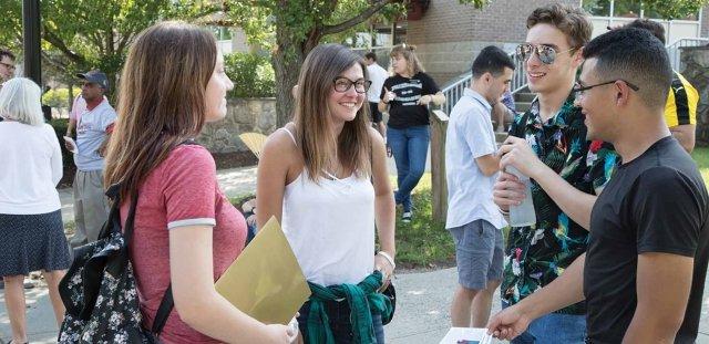 Students talking in small groups on the quad