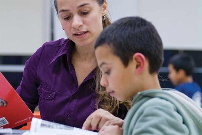 teacher working with a student